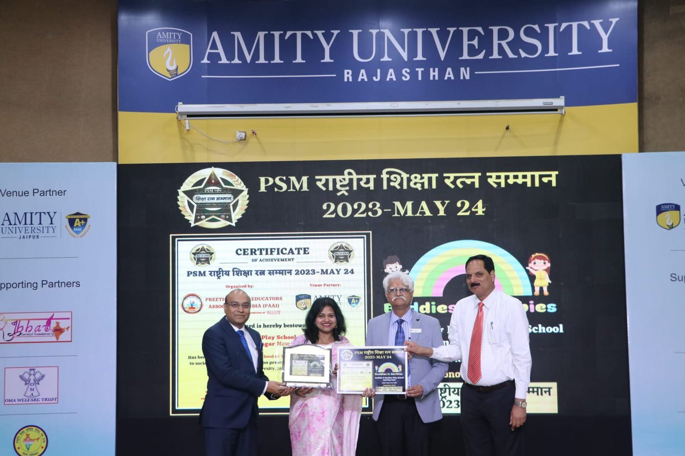 Award being presented on stage at Amity University, Rajasthan