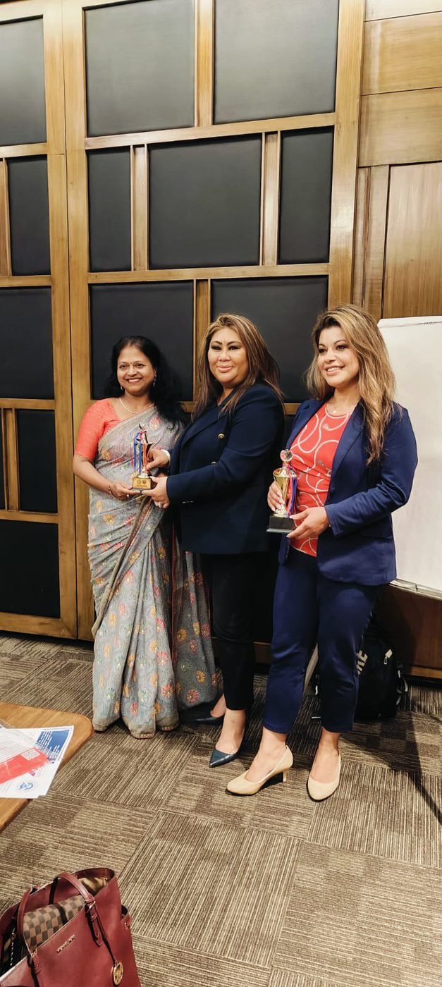 Holding a trophy with two award presenters