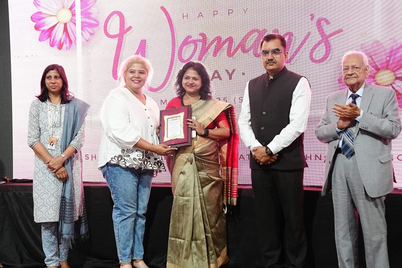 Award presented on stage at a Women’s Day ceremony